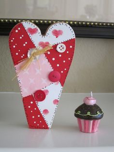 a cupcake next to a heart shaped box