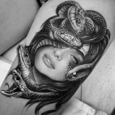 a woman's stomach with a snake on it and two snakes around her head