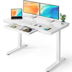 two computer monitors sitting on top of a white desk