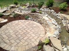 a brick patio with water feature in the middle