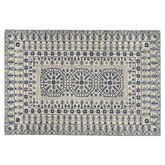 a blue and white rug with an intricate design on the bottom, in front of a white background