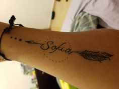 a woman's arm with an arrow and the word sofia written on it