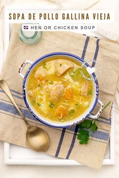 a bowl of soup with chicken and parsley in it on top of a table