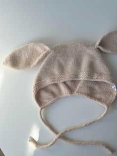 Baby hat "Bunny" 🐰 with ties ◾️It is a handmade product - knitted.  ◾️Yarn:  angora ◾️Size: 12-18 months  ◾️Color: Beige   🔴The bunny booties are sold separately as well - you can order them by link 🔗 https://irinasmade.etsy.com/listing/1702212009 How to care: ▫️hand wash in cool water ▫️dry on a flat surface, you can use a towel 🔺Do not iron ▫️the tag can be removed before washing Bunny Ears Hat, Baby Bunny Outfit, Angora Bunny, Knitted Bunny, Hat With Ears, Hat For Baby, Small Rabbit, Bunny Hat, Bunny Outfit