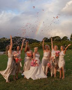 a group of bridesmaids are throwing confetti in the air with their hands