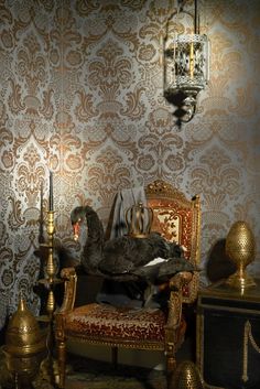 a fancy chair with a turkey on it in front of a wallpapered room