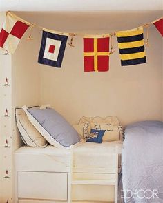 there is a bed with some flags hanging above it