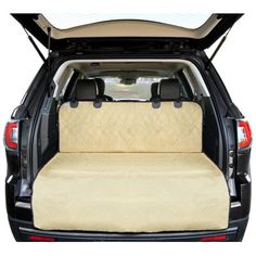 the back end of a car with its cargo compartment open and beige carpeting on it