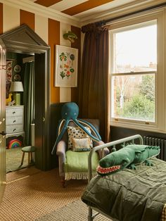 a bedroom decorated in green and orange with an octopus chair next to the bed,