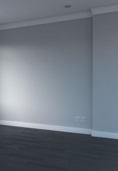 an empty room with white walls and wood floors is shown in the foreground, there are no people or objects on the floor