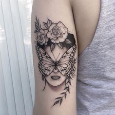 a woman's arm with flowers and a butterfly on it, in black ink