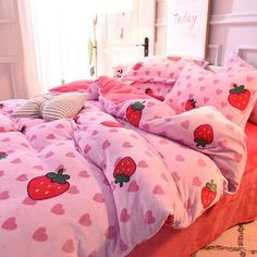 a bed with hearts and strawberrys on it