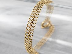 This chain bracelet is classic with a twist! Made up of woven infinity links, the 18-karat gold chain has a high polish that catches the light beautifully. A true wardrobe staple, this bracelet is versatile and easy to layer with your favorite pieces.Metal: 18K Yellow GoldWidth: 7.0 mmLength: 8 InchesMarks: "U56" Stamped on the clasp Bracelet Fancy, Bracelet Layering, 18k Gold Bracelet, Wedding Jewelry Bracelets, Layered Bracelets, Wardrobe Basics, Wedding Bracelet, New Hampshire, Bracelet Gift