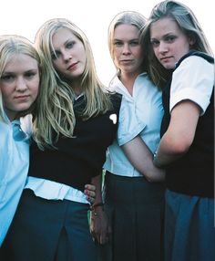 four young women are posing for the camera