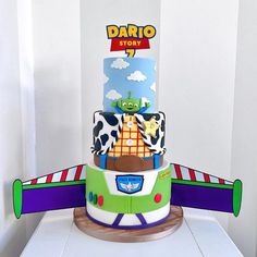 a three tiered cake decorated with toy story characters