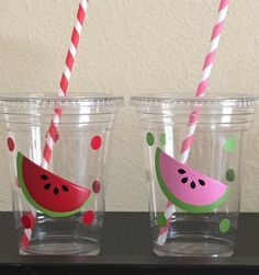 three glasses with watermelon straws in them