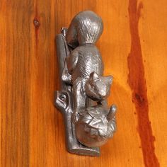 a metal cat figurine sitting on top of a wooden table