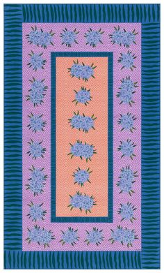 a purple and blue quilt with flowers on it's border, in the center