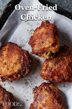 four fried chicken patties sitting on top of a pan