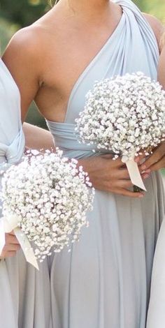 the bridesmaids are holding bouquets of baby's breath