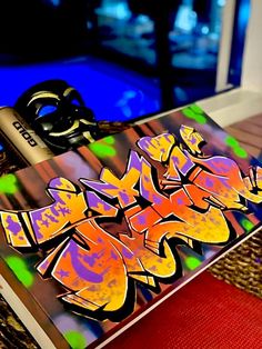 a pair of scissors sitting on top of a piece of paper covered in graffitti