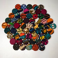 a bunch of different colored rocks on a white surface