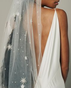 the back of a bride's veil with snowflakes on it