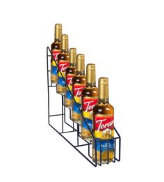 six bottles of torani oil in a rack on a white background with clippings