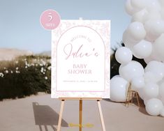 there is a sign that says welcome to julia's baby shower with balloons in the background