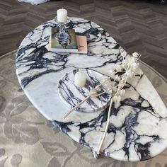 a marble coffee table with candles on it