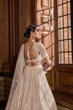 This lehenga set features intricate embroidery in pearl, sequin and bugle bead in champagne tones. The blouse has a sweetheart neckline and shows tassels at the waist. It is paired with a matching net dupatta.From Seema Gujral's A Royal Affair collection. DELIVERY TIMEPlease allow 8-12 weeks for your outfit to arrive. FABRIC DETAILSNet Professional cleaning only. Pearl Lehenga, A Royal Affair, Gown Skirt, Designer Party Wear Dresses, Net Dupatta, Intricate Embroidery, Bugle Beads, 12 Weeks, Party Wear Dresses