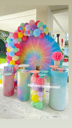 an outdoor party with balloons, confetti and decorations