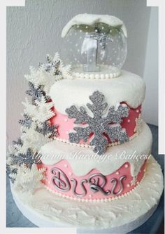 a three tiered cake decorated with snowflakes