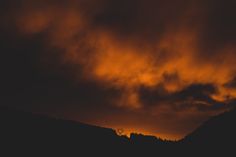 the sky is dark and orange as it appears to be overcast with some clouds