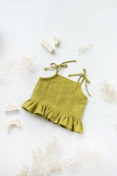 Girls linen strap ruffle top in Pear green color.  Linen top  with ties. Sleeveless boho children top. Summer tie strap top  for toddlers. * Please note that actual colors may vary due to your computer resolution and monitor color restrictions. To have a perfect color match you can always order a linen samples. * Please, write up to 10 color fabric samples if you would like to get them with your purchase from my shop. Samples will be added for free  . Details: - 100% Lithuanian linen; - very sof Sleeveless Light Green Summer Tops, Cute Sleeveless Tie Back Tops, Green Summer Tank Top With Adjustable Straps, Beach Green Tops With Tie Straps, Beach Tops With Tie Straps In Green, Green Tie-strap Tops For Beach, Green Tie Strap Top For Beach, Green Sleeveless Top With Tie Straps, Green Cotton Tops With Tie Straps