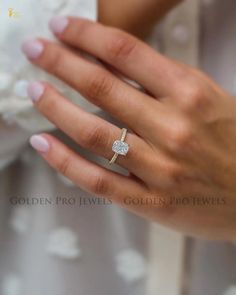 a woman's hand with a diamond ring on it