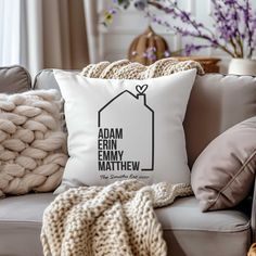 a white pillow with the words adam and emimy on it sitting on a couch