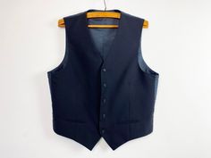 Vintage Blue Wool Blend Mens Vest Steampunk Vest Gentlemen's Edwardian Waistcoat Victorian Formal Wear Waistcoat Blue Size Large Blue Mens Vest Label size: 54 / R44  Please check measurements to insure a proper fit. Remember to allow yourself some extra room for movement. You can compare these with something from your closet that fits you well. Measurements: Pit to pit: 23 inch / 58.5 cm Length: 26 inch / 66 cm Condition: Great Vintage Condition Please note that the item is vintage and usually s Formal Blue Vest With Buttons, Fitted Blue Vest Outerwear, Tailored Blue Vest For Fall, Navy Fitted Winter Vest, Fitted Blue Vest With Buttons, Navy Fitted Vest For Winter, Navy Fitted Vest For Fall, Edwardian Waistcoat, Mens Formal Vest