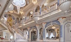 an elaborately decorated room with stairs and chandeliers