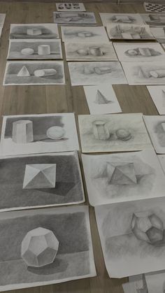 many different shapes and sizes of paper on a table with pencils laid out in front of them