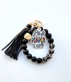 a black beaded bracelet with the words best mama ever and an animal print tassel