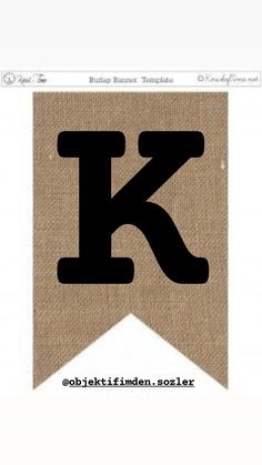 the letter k is made out of burlap paper and has black letters on it