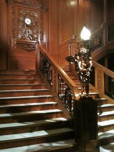 an ornate staircase in a building with wooden paneling