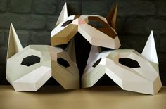 an origami dog mask sitting on top of a table next to another animal