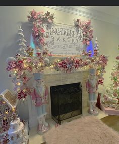 a fireplace decorated with pink and white christmas decorations in front of a sign that reads gingerbread bakery