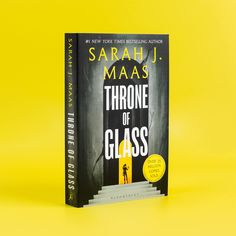 the book throne of glass by saraah j maas is on a yellow background