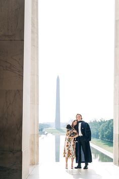 a man and woman standing in front of the washington monument