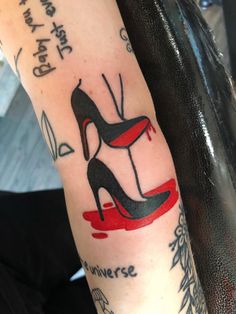 a woman with a tattoo on her arm has a high heeled shoe and words