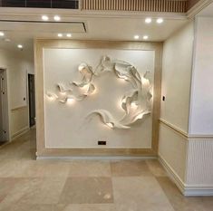 a large white wall with some lights on it's sides and an abstract sculpture in the middle