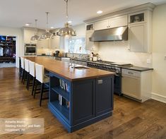 a large kitchen with an island in the middle